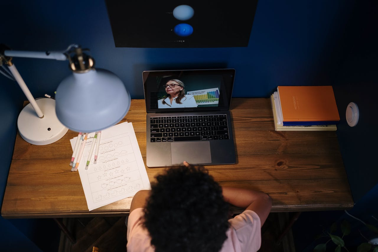 a person is learning from watching and writing down