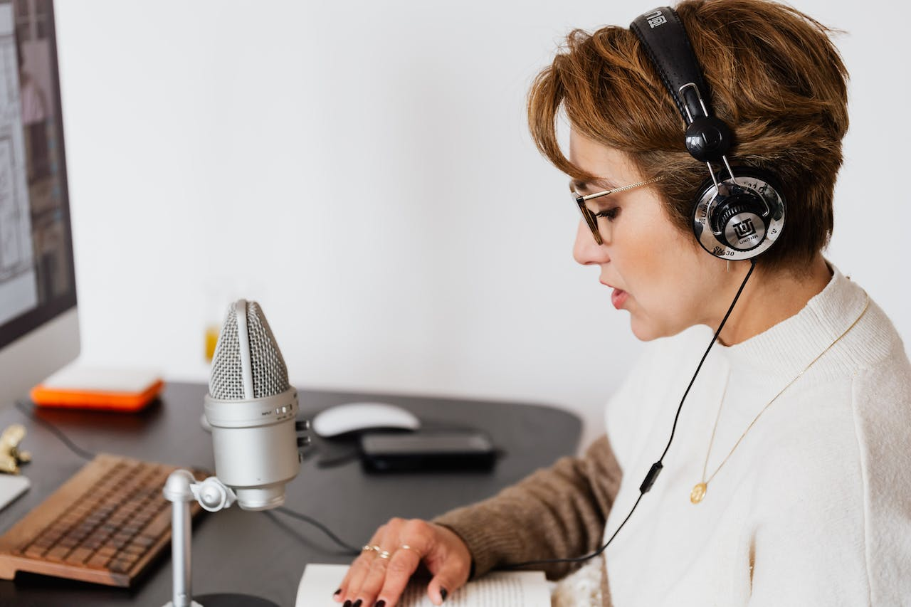 a woman reading a book while wearning headphones